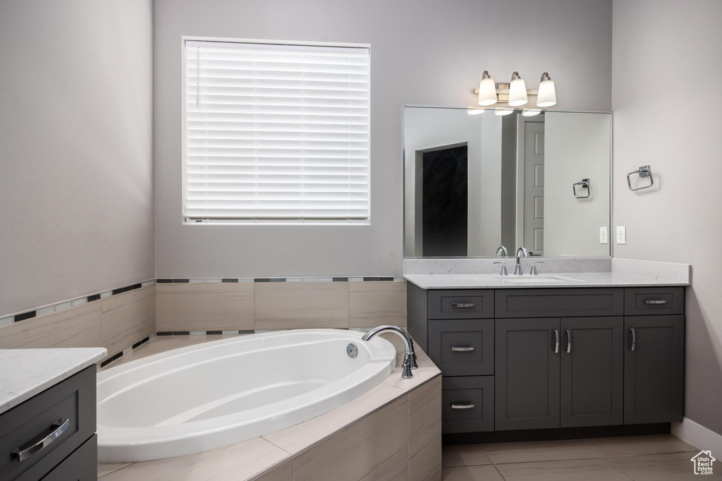 Bathroom featuring vanity and a bath