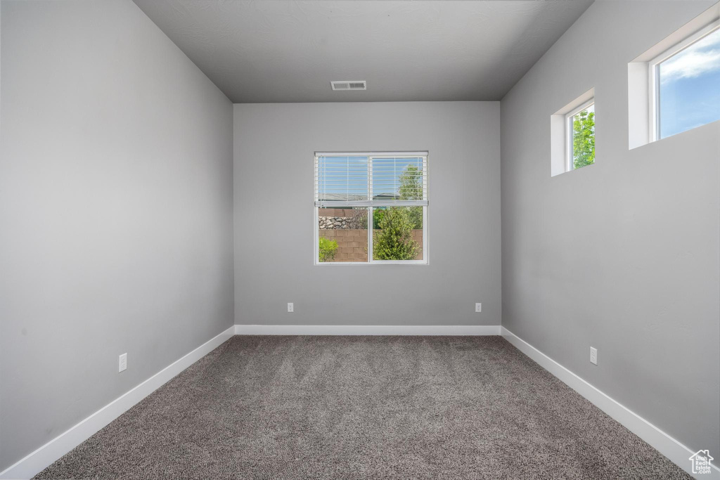 Spare room with carpet floors and baseboards