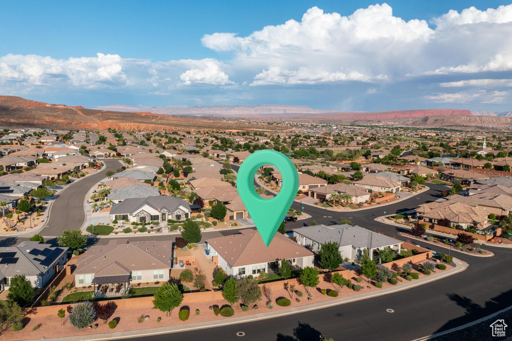 Aerial view of property's location featuring a mountainous background and nearby suburban area