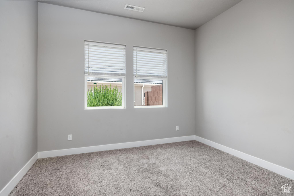 Spare room with carpet floors and baseboards