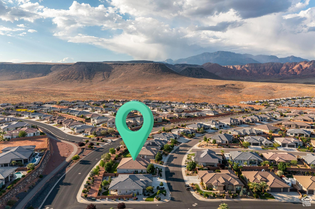 Aerial view of property's location featuring nearby suburban area and a mountain backdrop