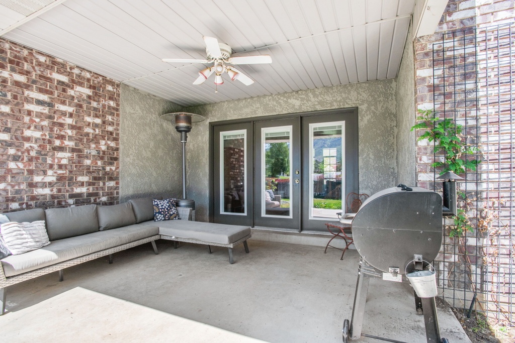 View of patio / terrace featuring french doors, an outdoor living space, ceiling fan, and grilling area