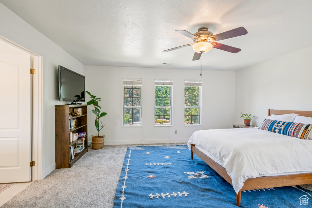 Bedroom with carpet, baseboards, and ceiling fan