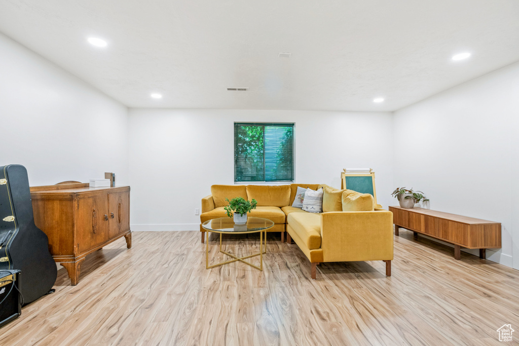 Living room featuring light wood finished floors, recessed lighting, and baseboards