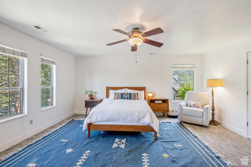 Carpeted bedroom with baseboards and ceiling fan
