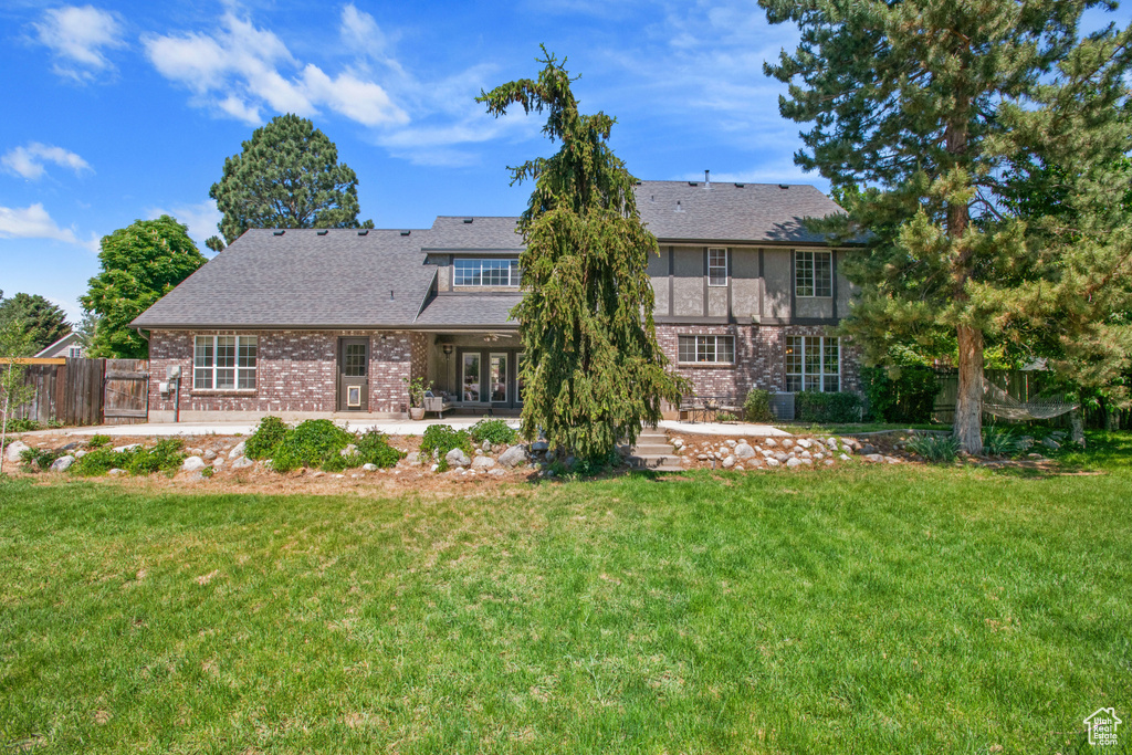 Rear view of property with a patio area, french doors, and brick siding
