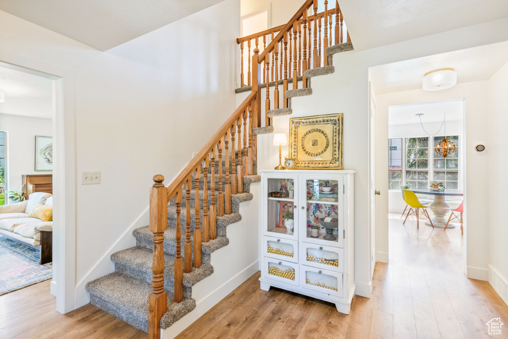 Stairway featuring wood finished floors and baseboards