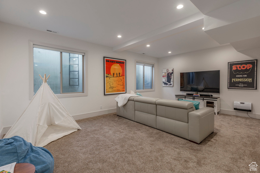 Living room featuring light carpet, recessed lighting, baseboards, and beamed ceiling
