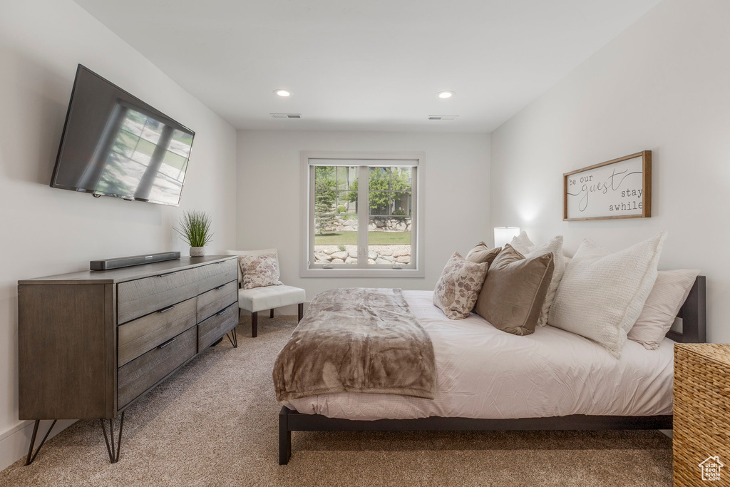 Bedroom featuring light colored carpet and recessed lighting