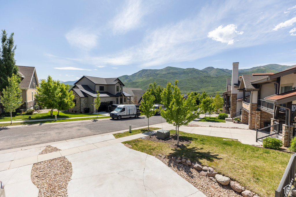 View of yard featuring a residential view and a mountain view