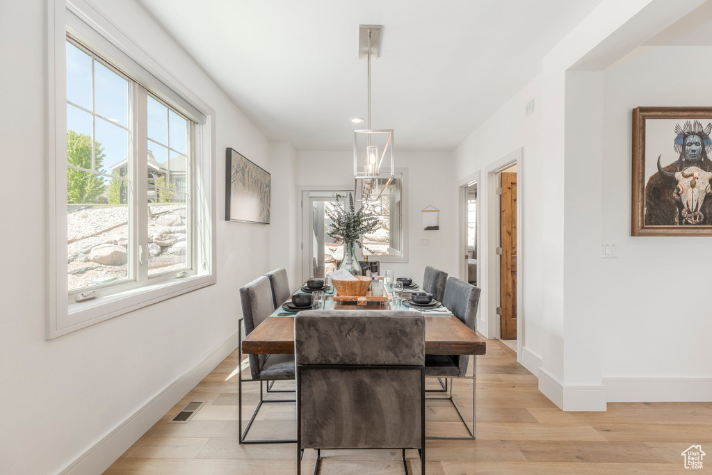 Dining room with baseboards, recessed lighting, and light wood-style floors