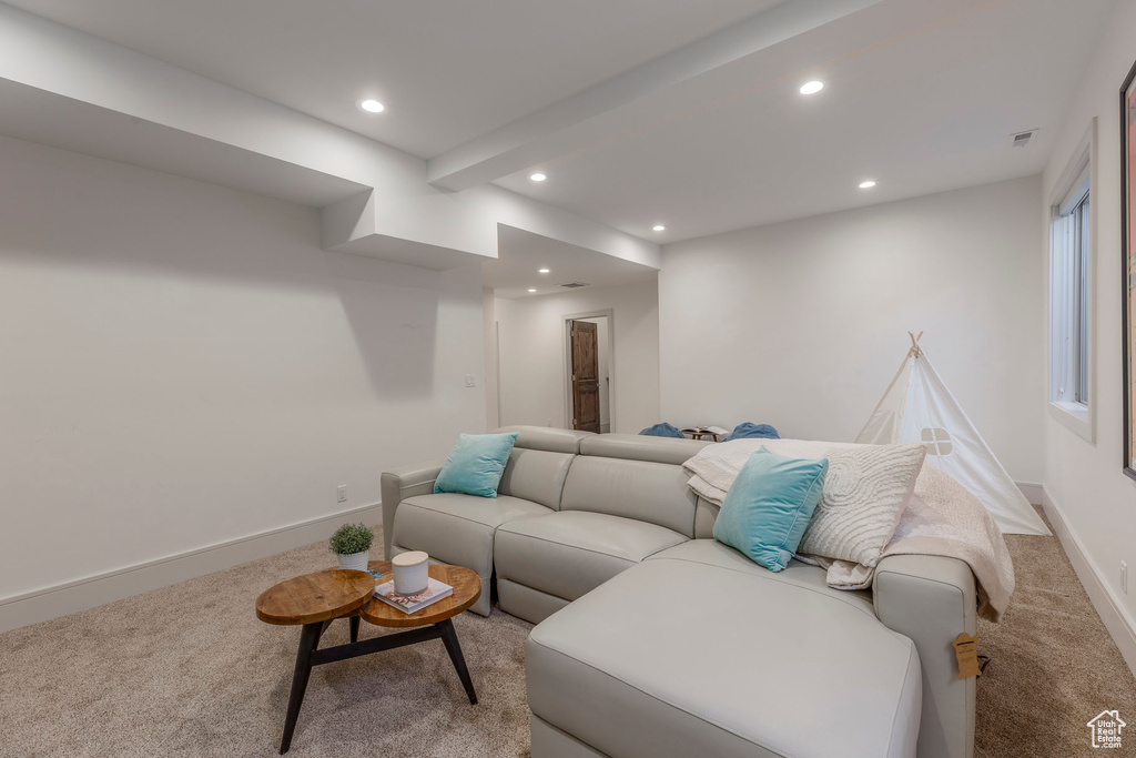 Carpeted living area featuring recessed lighting and baseboards