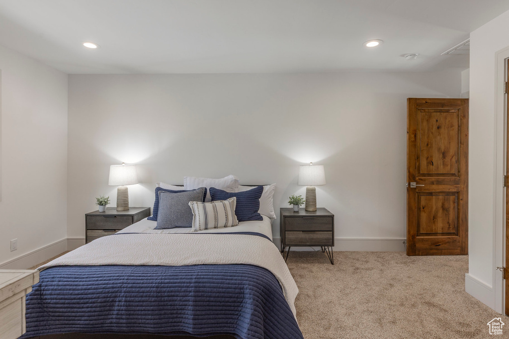 Carpeted bedroom with recessed lighting and baseboards