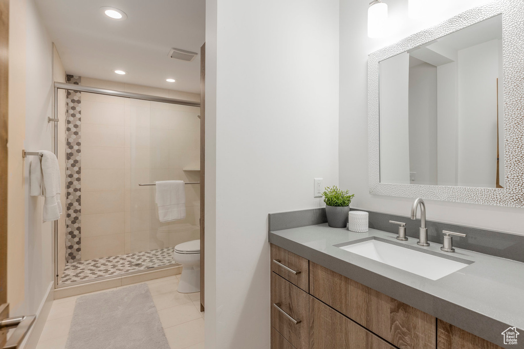 Bathroom featuring a shower stall, toilet, vanity, recessed lighting, and tile patterned floors