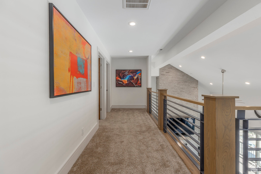 Hall with light colored carpet, recessed lighting, baseboards, and an upstairs landing