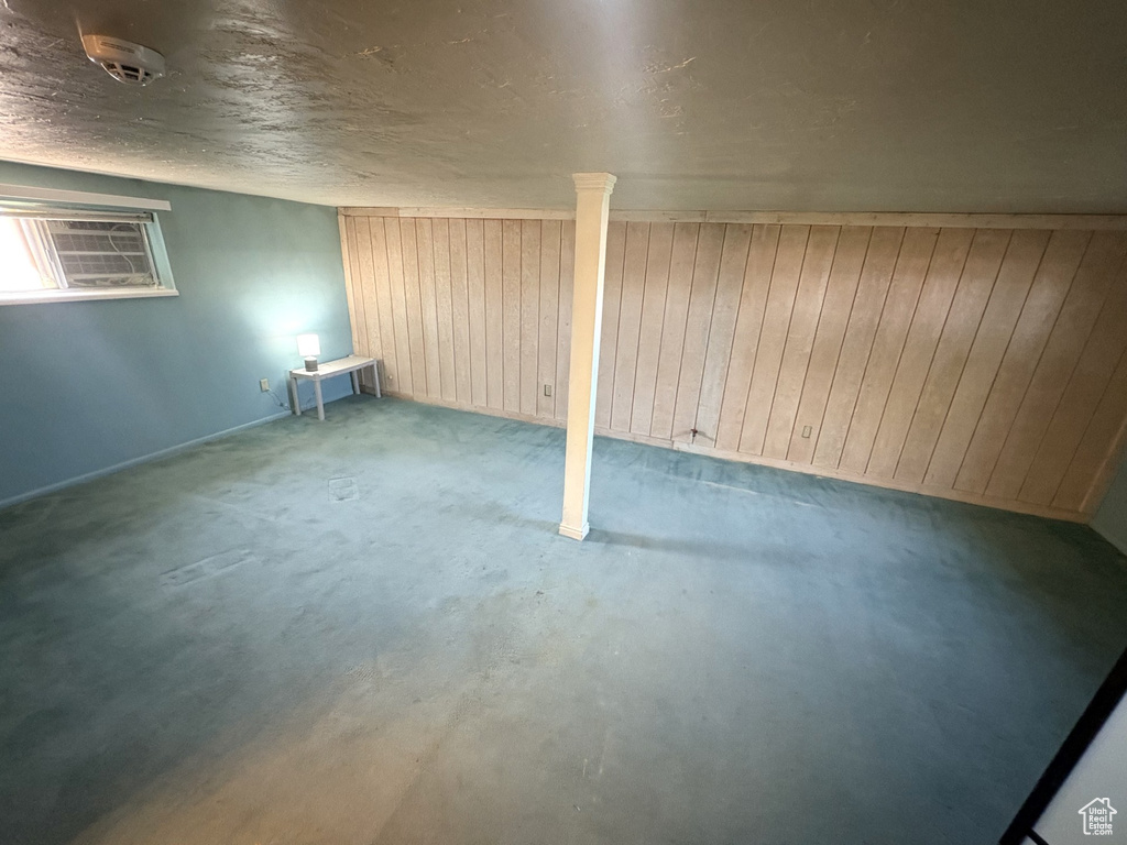 Unfurnished room with wood walls