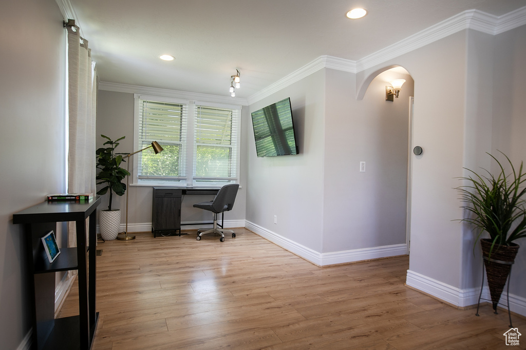 Office space with wood finished floors, baseboards, arched walkways, crown molding, and recessed lighting