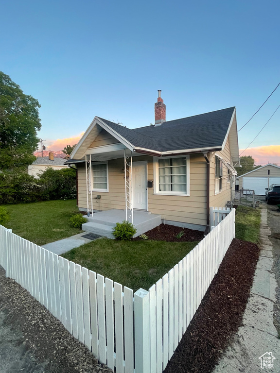 Bungalow-style house with covered porch and a chimney