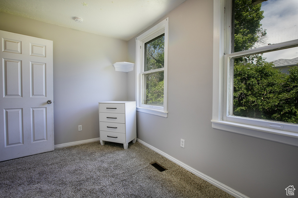 Unfurnished bedroom with carpet and baseboards