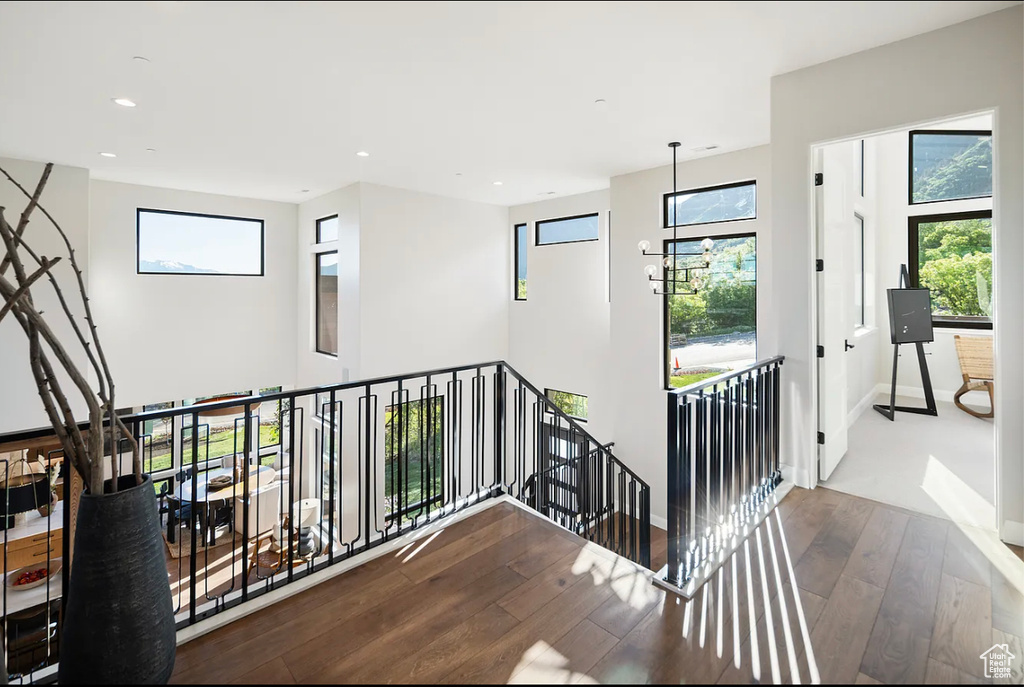 Stairs with wood-type flooring, recessed lighting, and baseboards