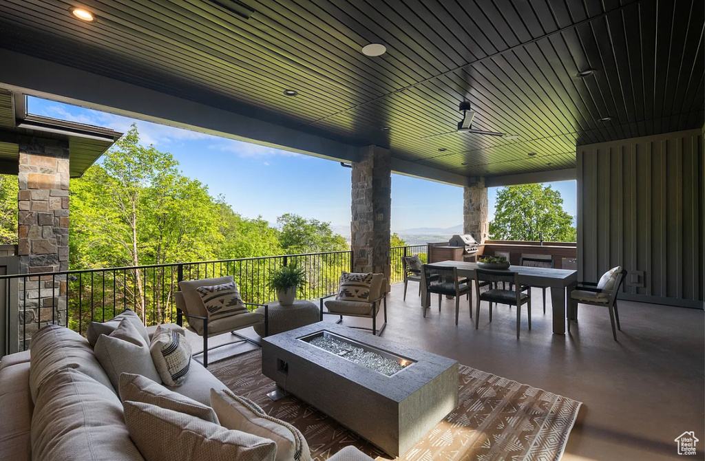 View of patio / terrace with an outdoor living space with a fire pit and outdoor dining area