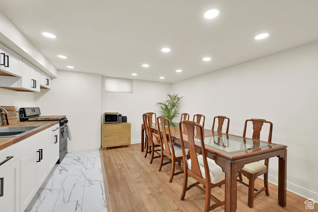 Dining area with recessed lighting and baseboards
