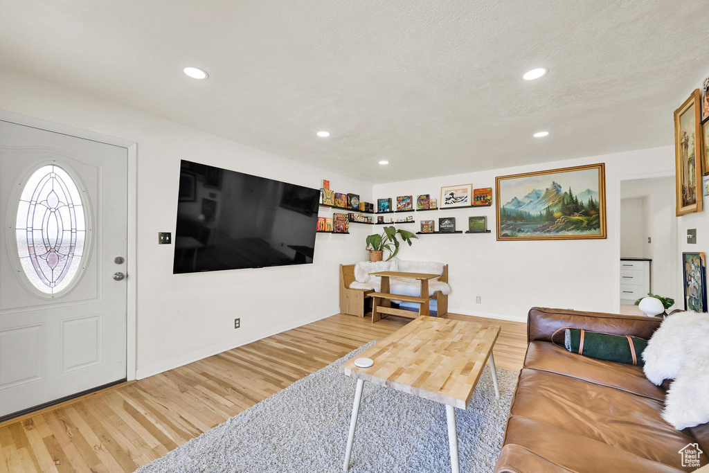Living area featuring wood finished floors, recessed lighting, and baseboards