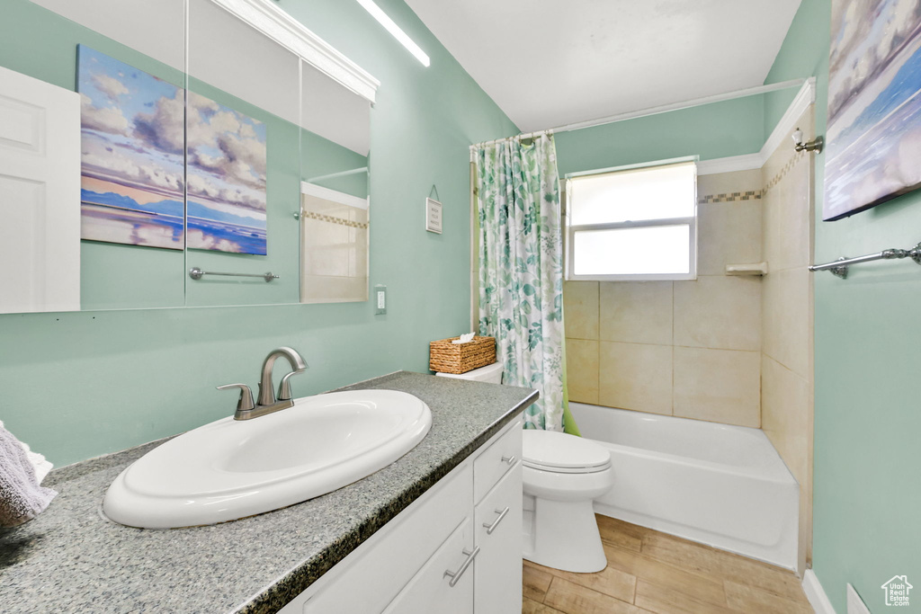 Bathroom with vanity, shower / bath combination with curtain, toilet, and wood finished floors