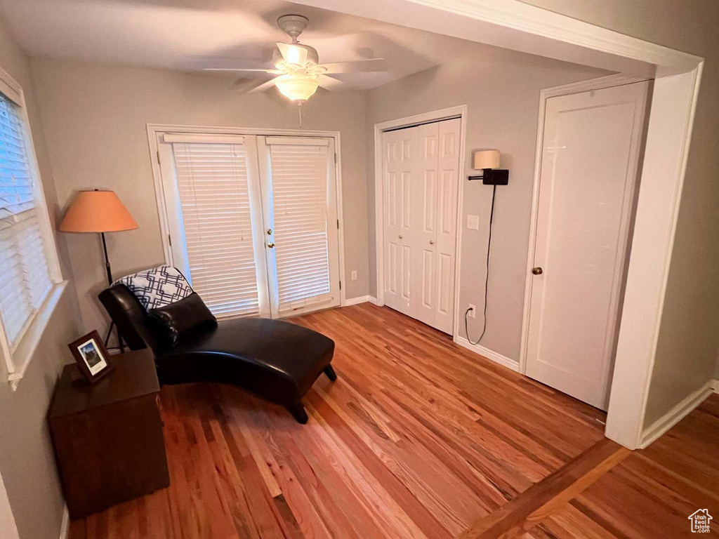 Sitting room with wood finished floors, ceiling fan, and baseboards