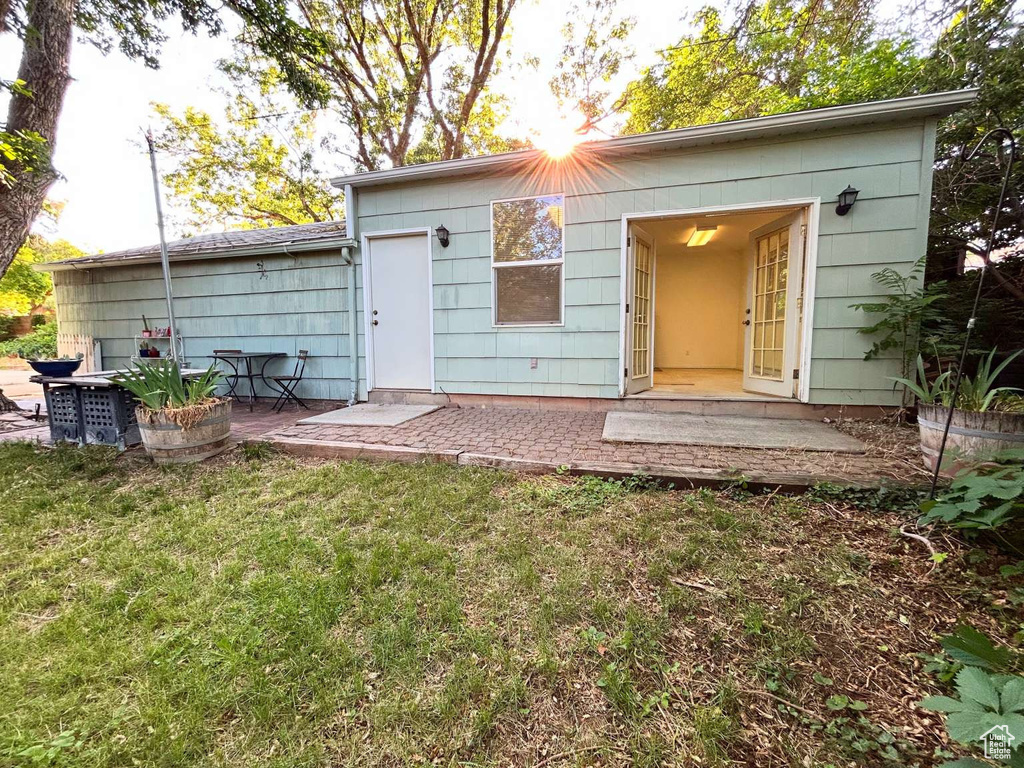 Rear view of house with a yard and a patio area