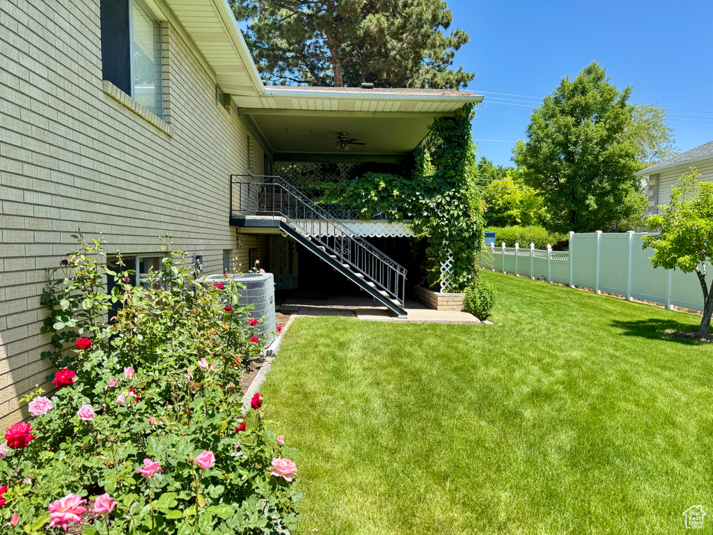 View of yard featuring stairs and central AC unit