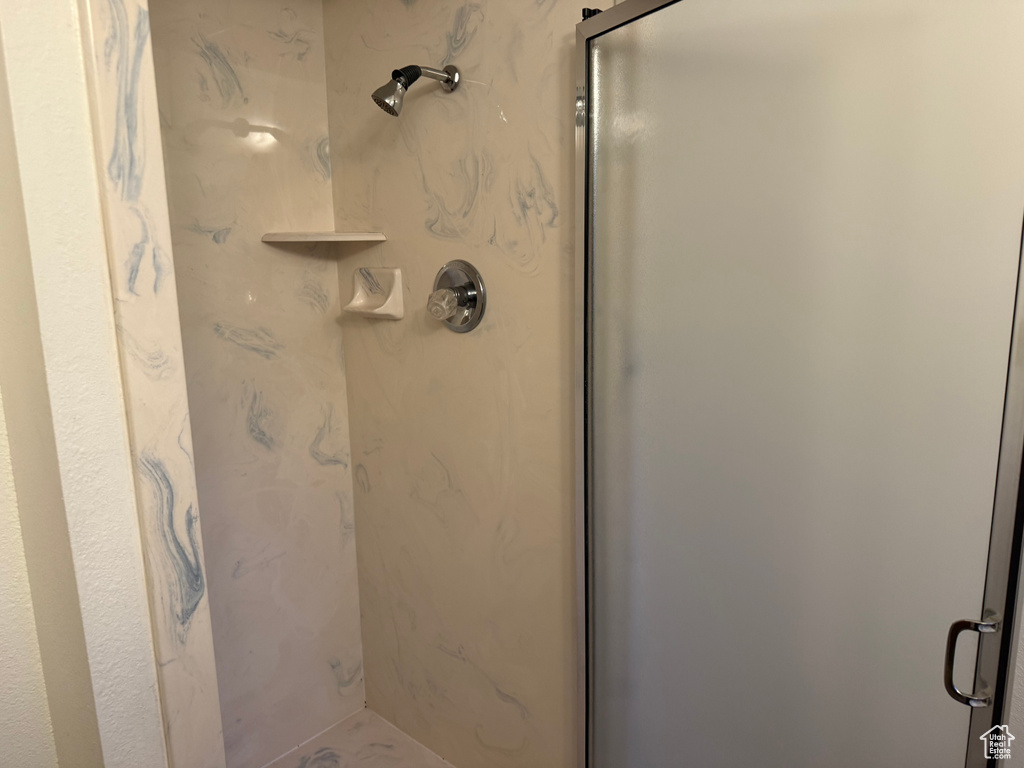 Bathroom featuring a marble finish shower