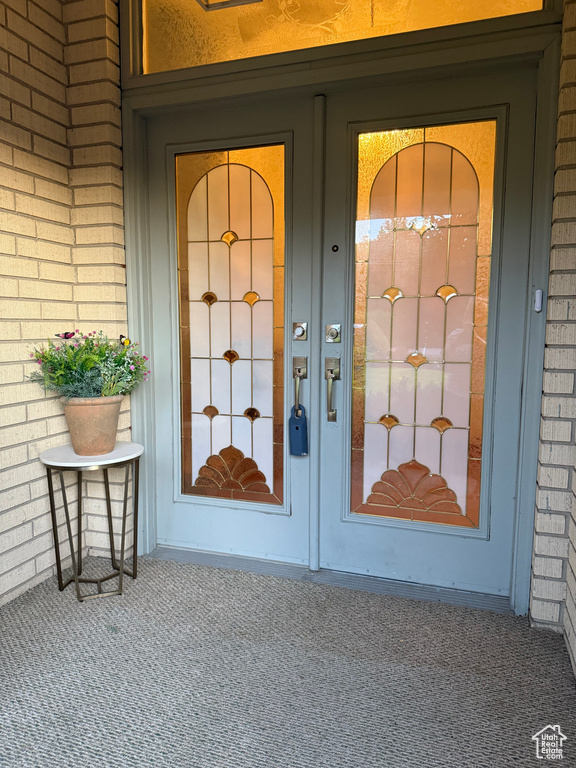 Entrance to property featuring brick siding