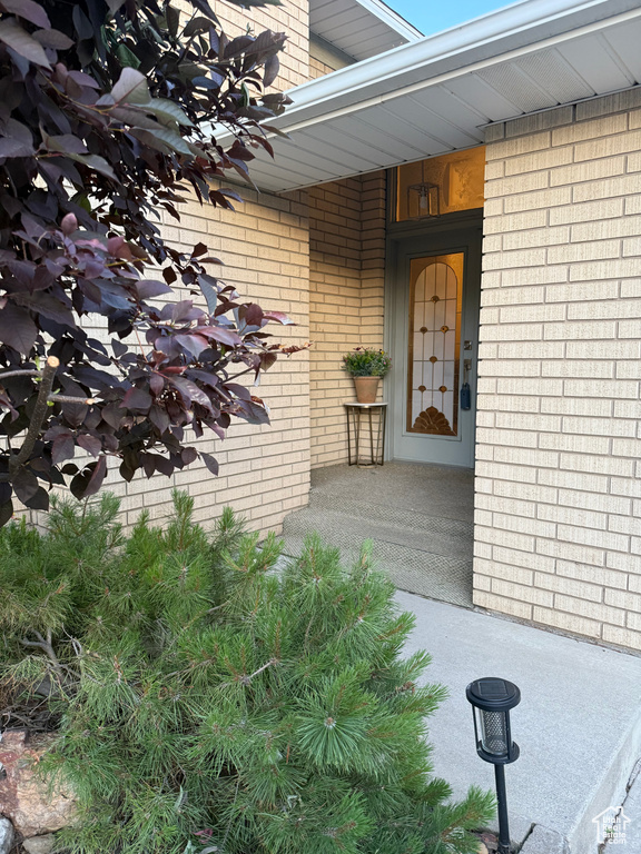 Entrance to property featuring brick siding