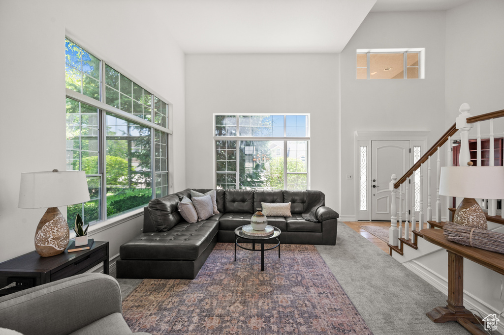 Living area with a high ceiling and stairs