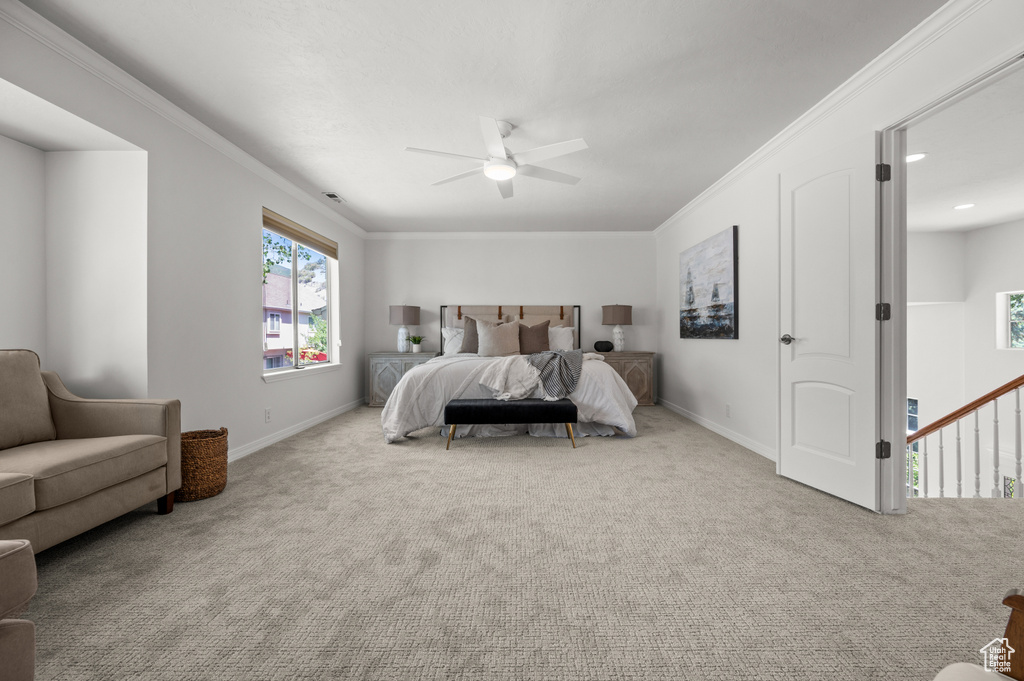 Carpeted bedroom featuring baseboards, ceiling fan, and ornamental molding