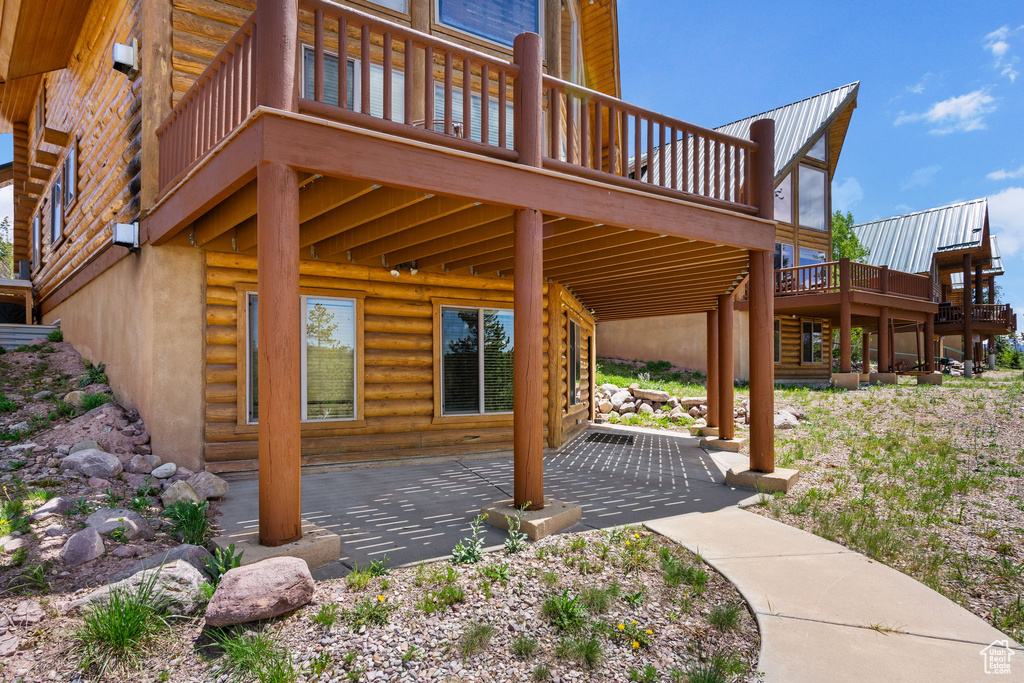 View of patio with a wooden deck