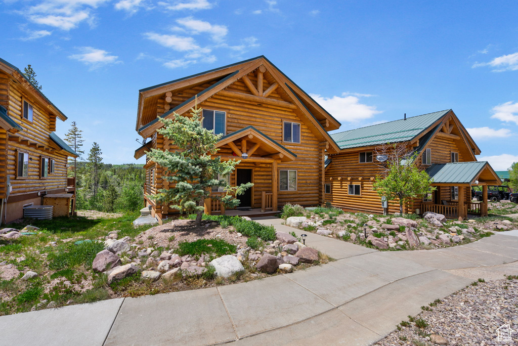 Log-style house featuring log siding and metal roof