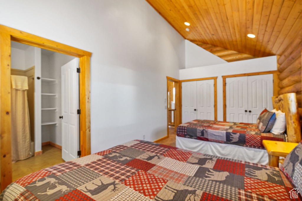Bedroom featuring wooden ceiling, two closets, vaulted ceiling, recessed lighting, and baseboards