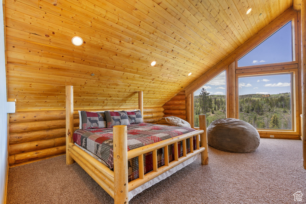 Carpeted bedroom featuring rustic walls, wood ceiling, and lofted ceiling