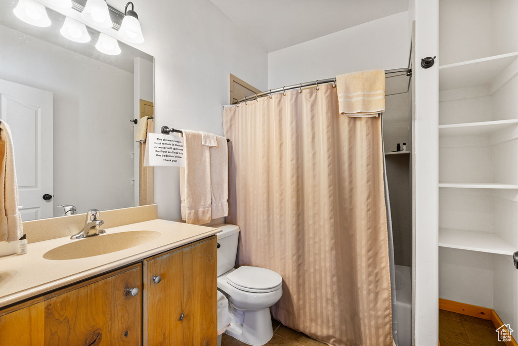 Full bathroom featuring vanity, toilet, and tile patterned floors
