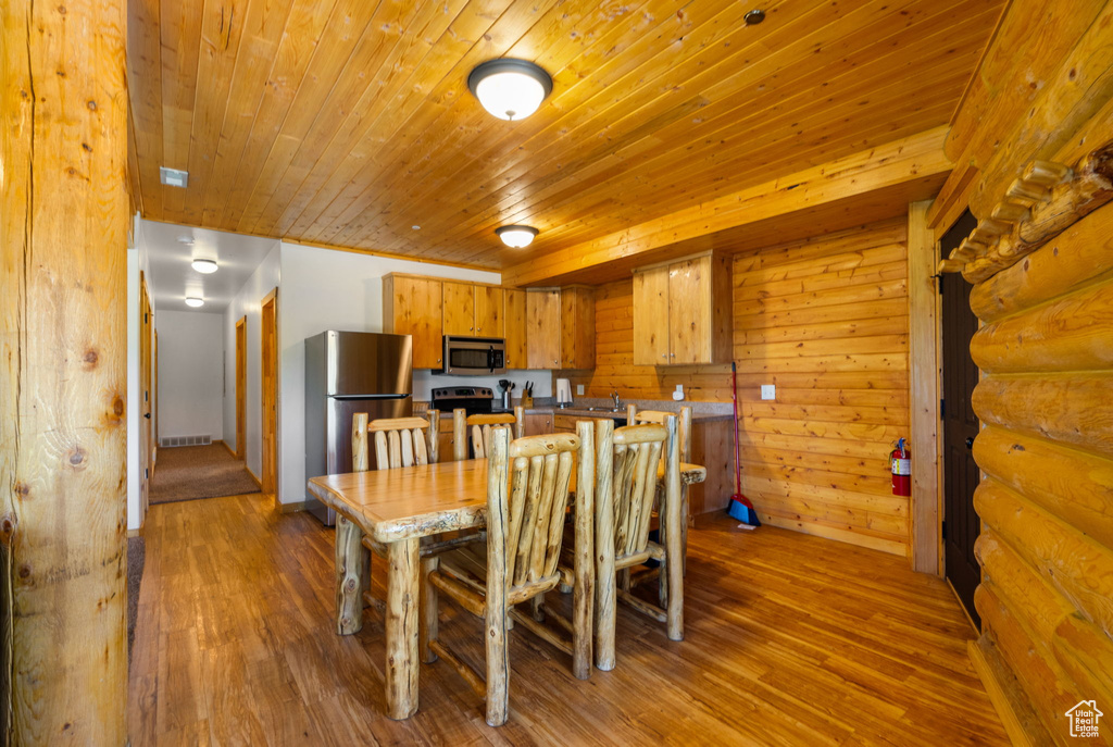 Dining space with wood finished floors and wooden ceiling