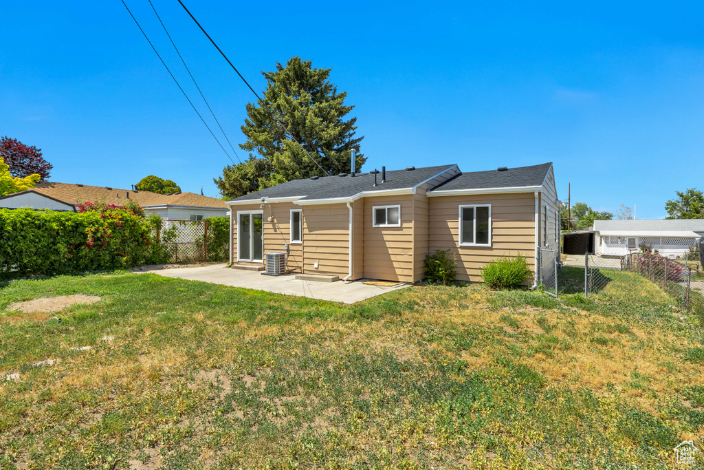 Rear view of house with a patio area and cooling unit