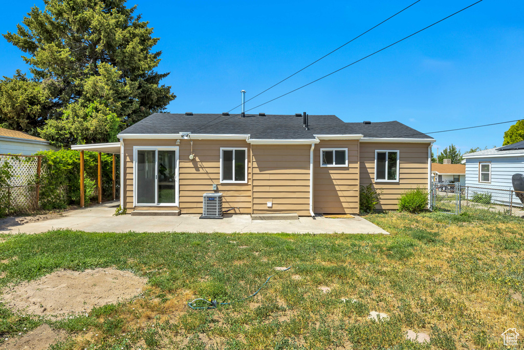 Back of property with a patio area and central air condition unit
