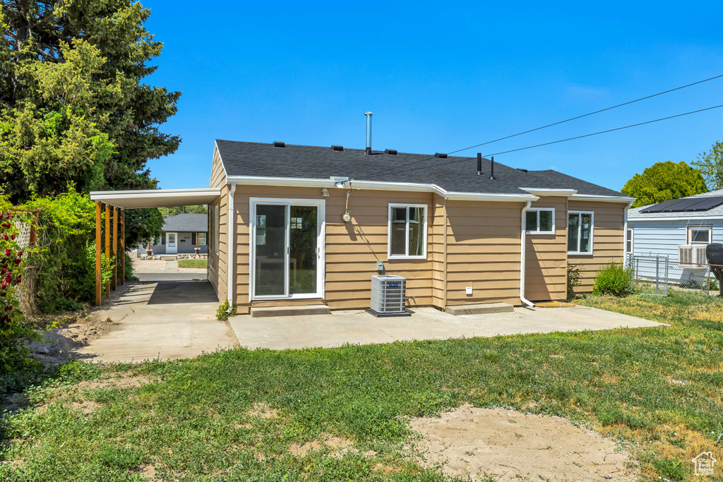 Rear view of property featuring central air condition unit and a patio