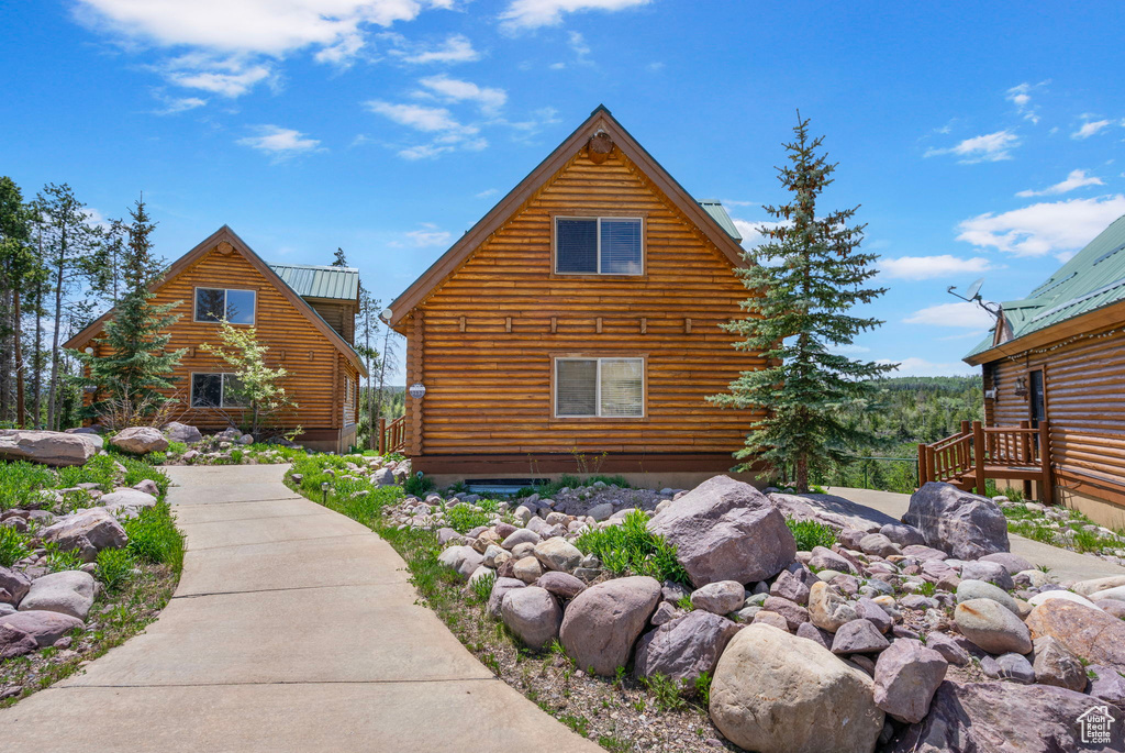 View of home\'s exterior featuring log siding and metal roof