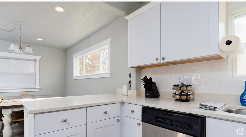 Kitchen with stainless steel dishwasher, a peninsula, plenty of natural light, tasteful backsplash, and recessed lighting