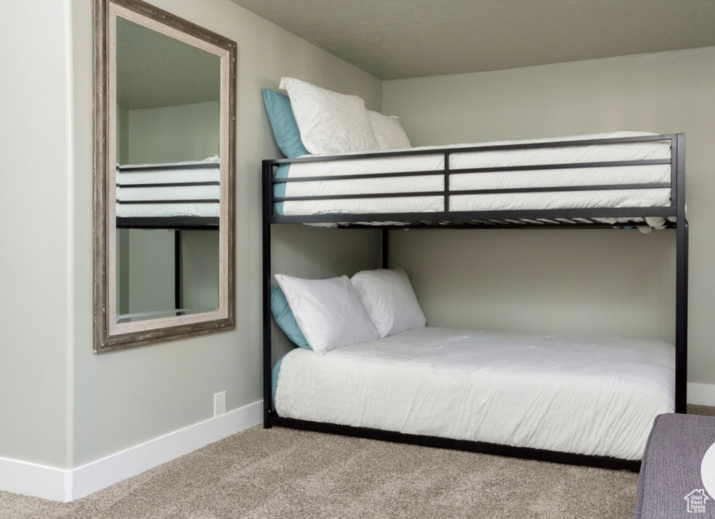 Carpeted bedroom featuring baseboards