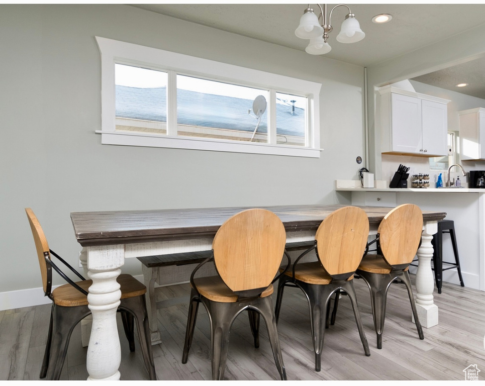 Dining space with a chandelier, recessed lighting, and light wood-style floors