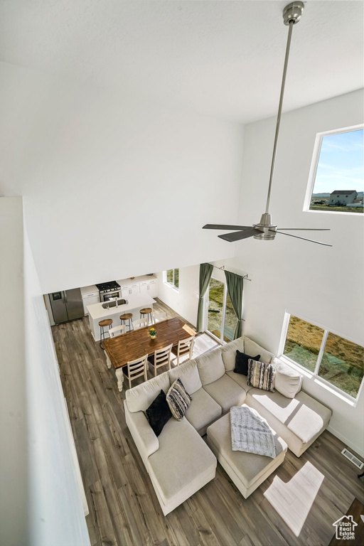 Living area featuring wood finished floors and ceiling fan